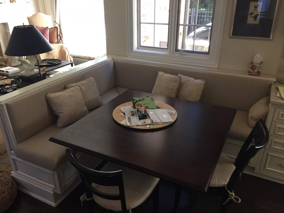 Breakfast nook with dark table and cushioned bench