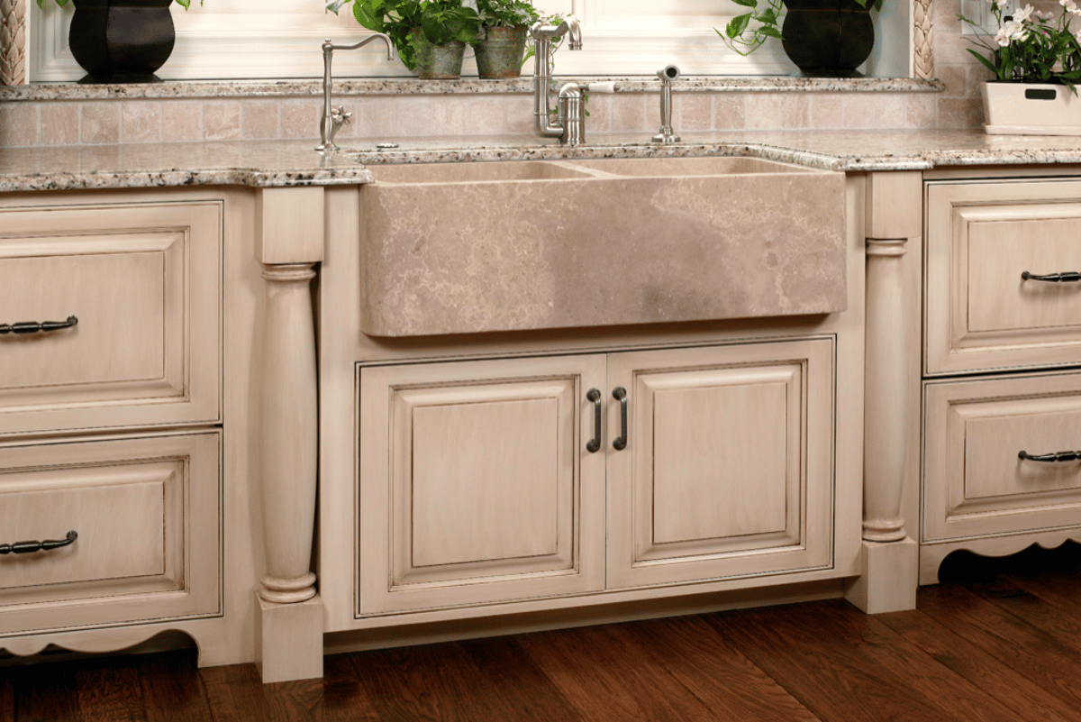 Apron-front kitchen sink with cream cabinets