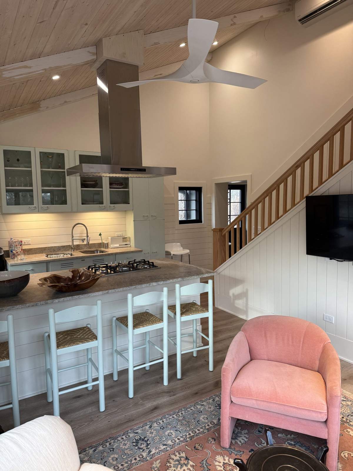Kitchen breakfast bar beside a wood staircase